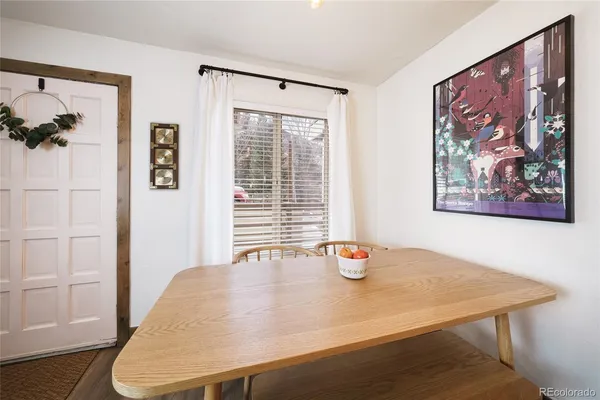 a view of a dining room with a table and chairs