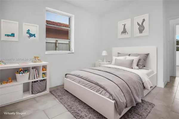 a bedroom with a bed and a potted plant
