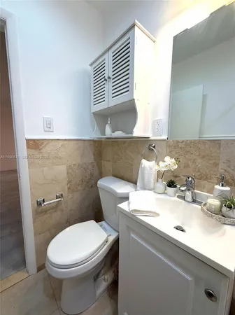 a bathroom with a toilet a sink and bathtub