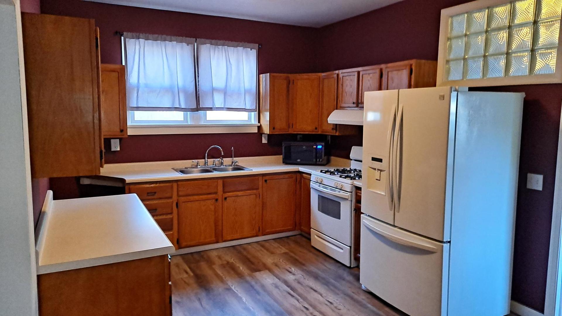 206 West Minnesota Street Spring Valley, IL 61362 - Photo 8 of 33 a kitchen with stainless steel appliances a refrigerator sink and cabinets
