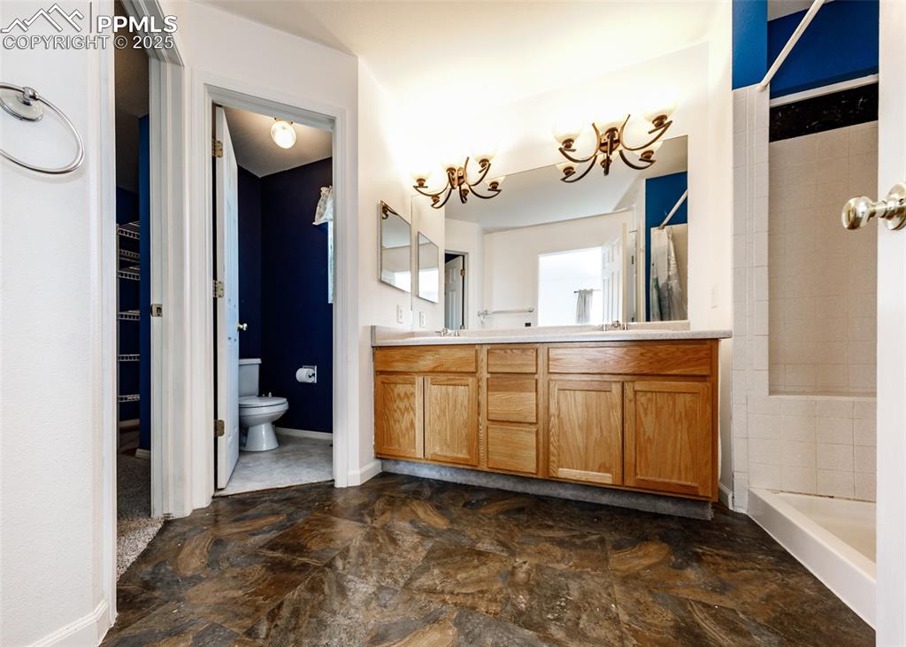 8119 Oliver Road Peyton, CO 80831 - Photo 21 of 38 a view of a bathroom with a sink and mirror with toilet