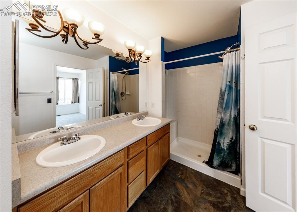 8119 Oliver Road Peyton, CO 80831 - Photo 23 of 38 a bathroom with a sink and a mirror