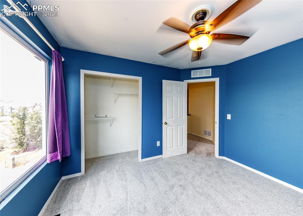 8119 Oliver Road Peyton, CO 80831 - Photo 25 of 38 a view of an empty room with window and a ceiling fan