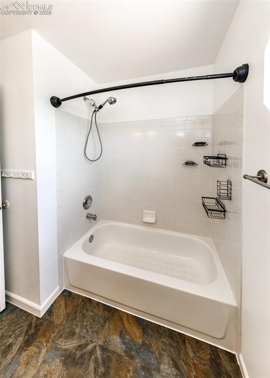 8119 Oliver Road Peyton, CO 80831 - Photo 27 of 38 a bathroom with a bath tub with a shower