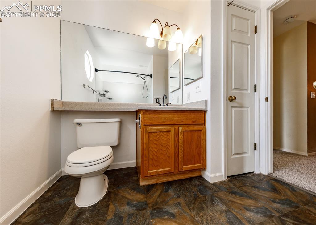 8119 Oliver Road Peyton, CO 80831 - Photo 28 of 38 a bathroom with a toilet sink and shower