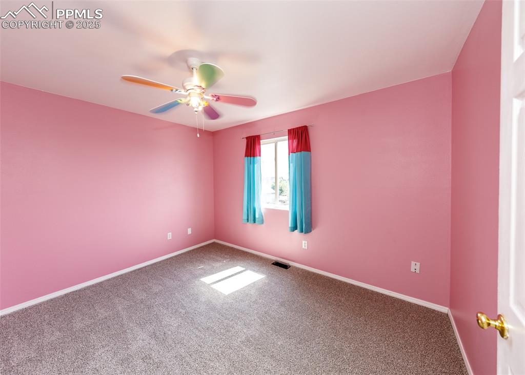 8119 Oliver Road Peyton, CO 80831 - Photo 30 of 38 a view of an empty room with window and chandelier fan