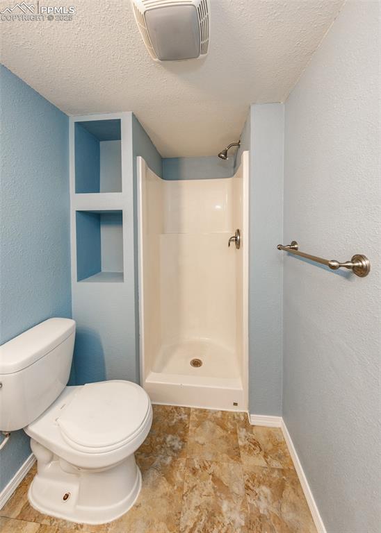 8119 Oliver Road Peyton, CO 80831 - Photo 34 of 38 a bathroom with a toilet and shower