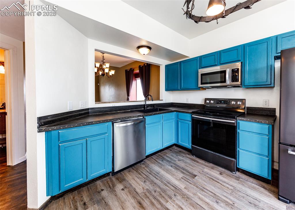 8119 Oliver Road Peyton, CO 80831 - Photo 5 of 38 a kitchen with granite countertop stainless steel appliances and wooden cabinets