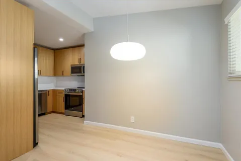 a view of a kitchen with a sink and dishwasher a stove top oven
