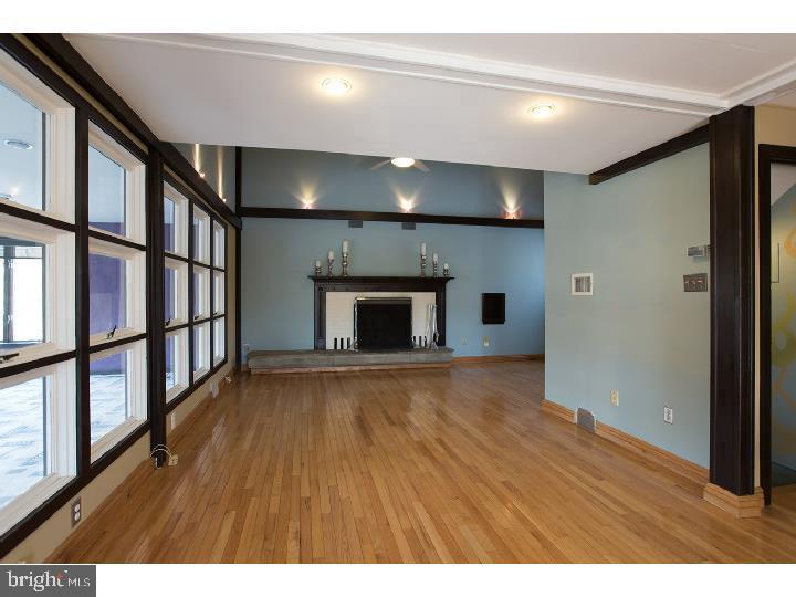 35 Beulah Road Doylestown, PA 18901 - Photo 5 of 41 view of empty room with wooden floor and fireplace