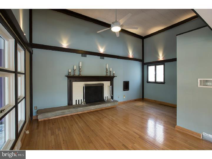 35 Beulah Road Doylestown, PA 18901 - Photo 6 of 41 a view of an empty room with wooden floor and a fireplace