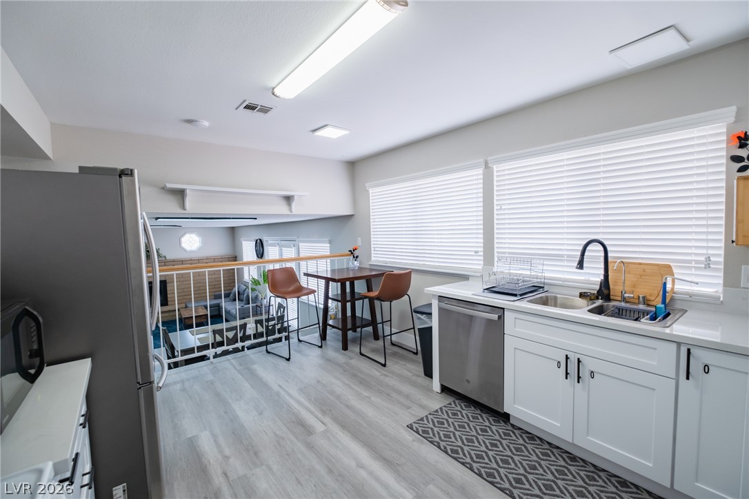 6356 West Viking Road Las Vegas, NV 89103 - Photo 14 of 51 Gleaming countertops and modern cabinetry overlook the open living space below.