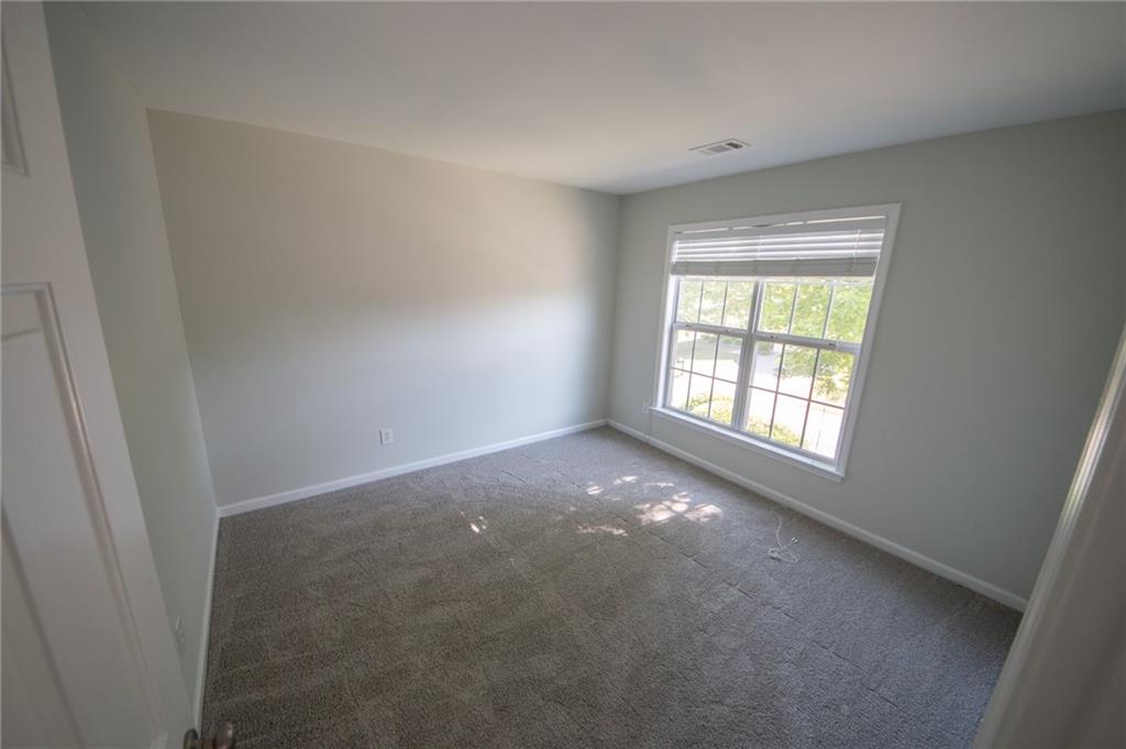 8145 Lockslay Way Suwanee, GA 30024 - Photo 11 of 18 an empty room with windows
