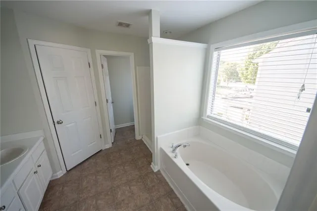a bathroom with a tub shower and a sink
