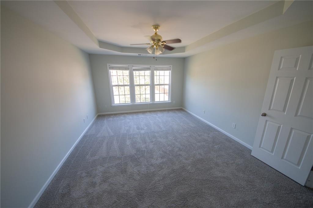 8145 Lockslay Way Suwanee, GA 30024 - Photo 17 of 18 a view of an empty room with a window