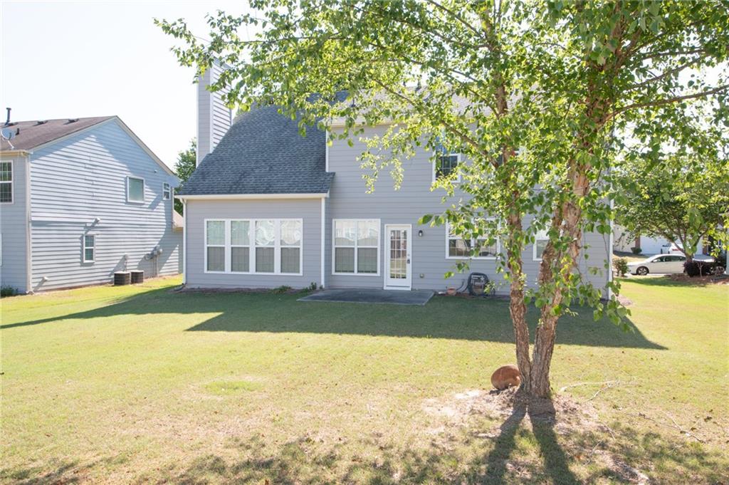 8145 Lockslay Way Suwanee, GA 30024 - Photo 18 of 18 a view of a house with swimming pool and a yard