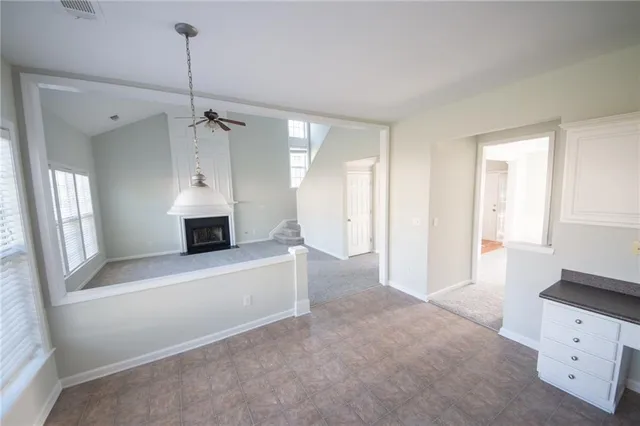a view of an empty room with a cabinet and a window