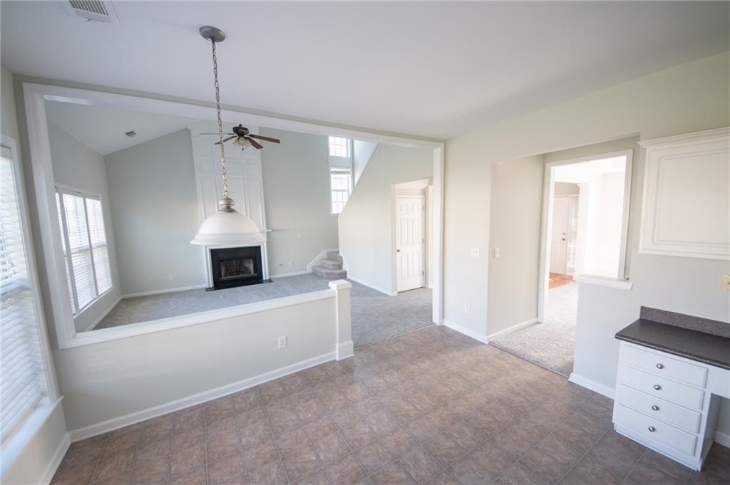 8145 Lockslay Way Suwanee, GA 30024 - Photo 4 of 18 a view of an empty room with a cabinet and a window