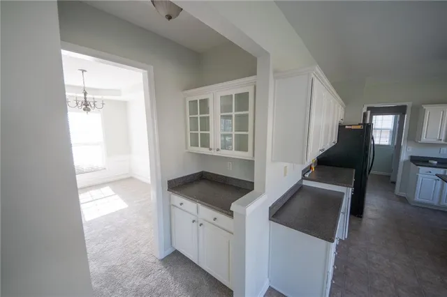 a kitchen with granite countertop a sink and a stove top oven