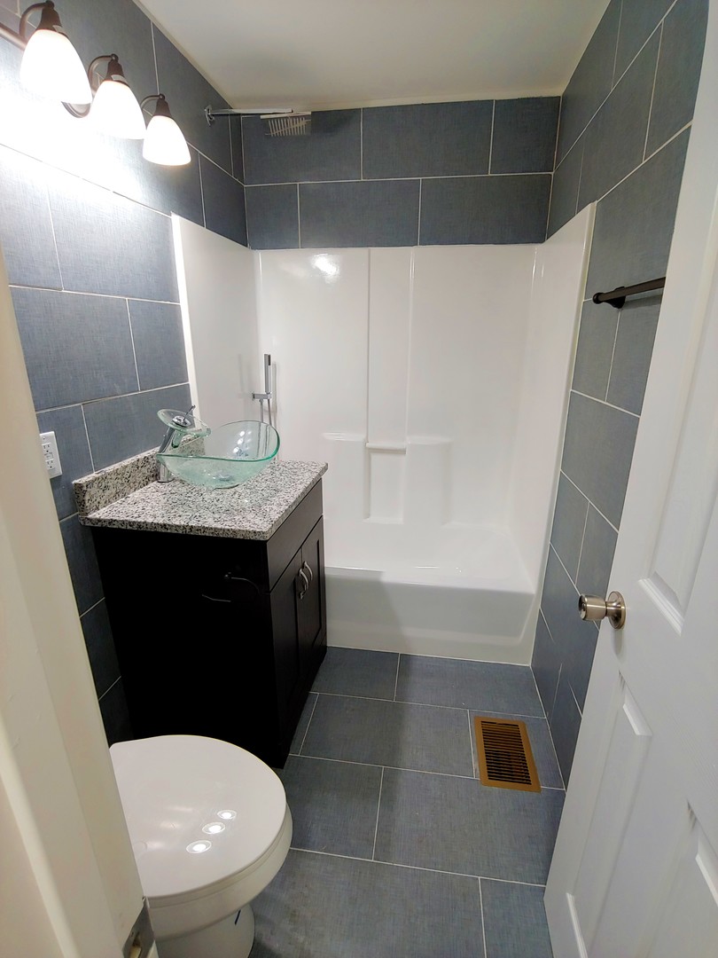 120 Edison Road Joliet, IL 60433 - Photo 12 of 21 a bathroom with a sink toilet and shower