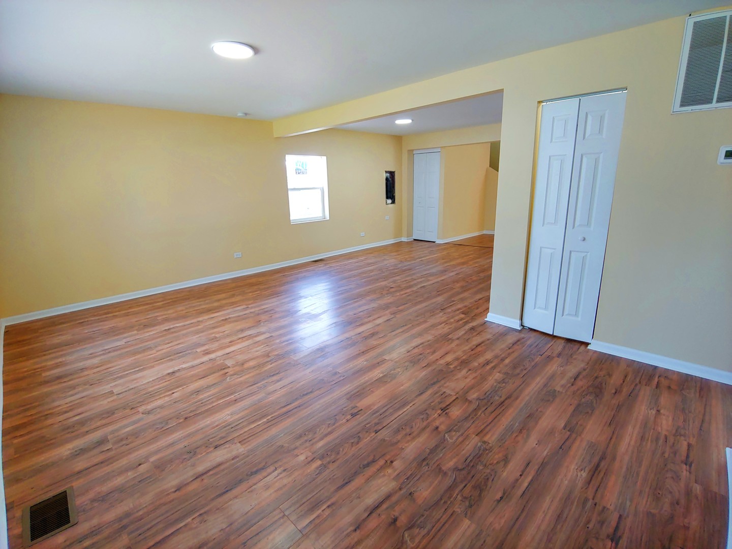 120 Edison Road Joliet, IL 60433 - Photo 4 of 21 an empty room with wooden floor and windows