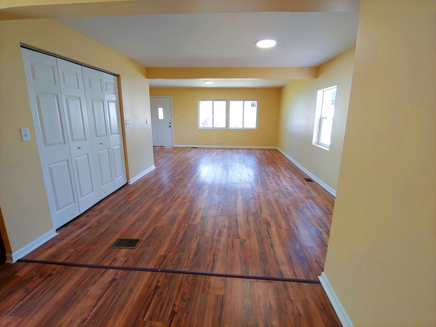 120 Edison Road Joliet, IL 60433 - Photo 5 of 21 wooden floor in an empty room with a window