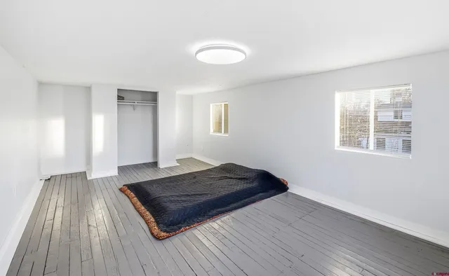 a living room with a couch and wooden floor