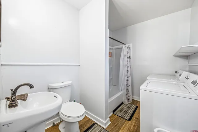 a bathroom with a sink toilet and a mirror