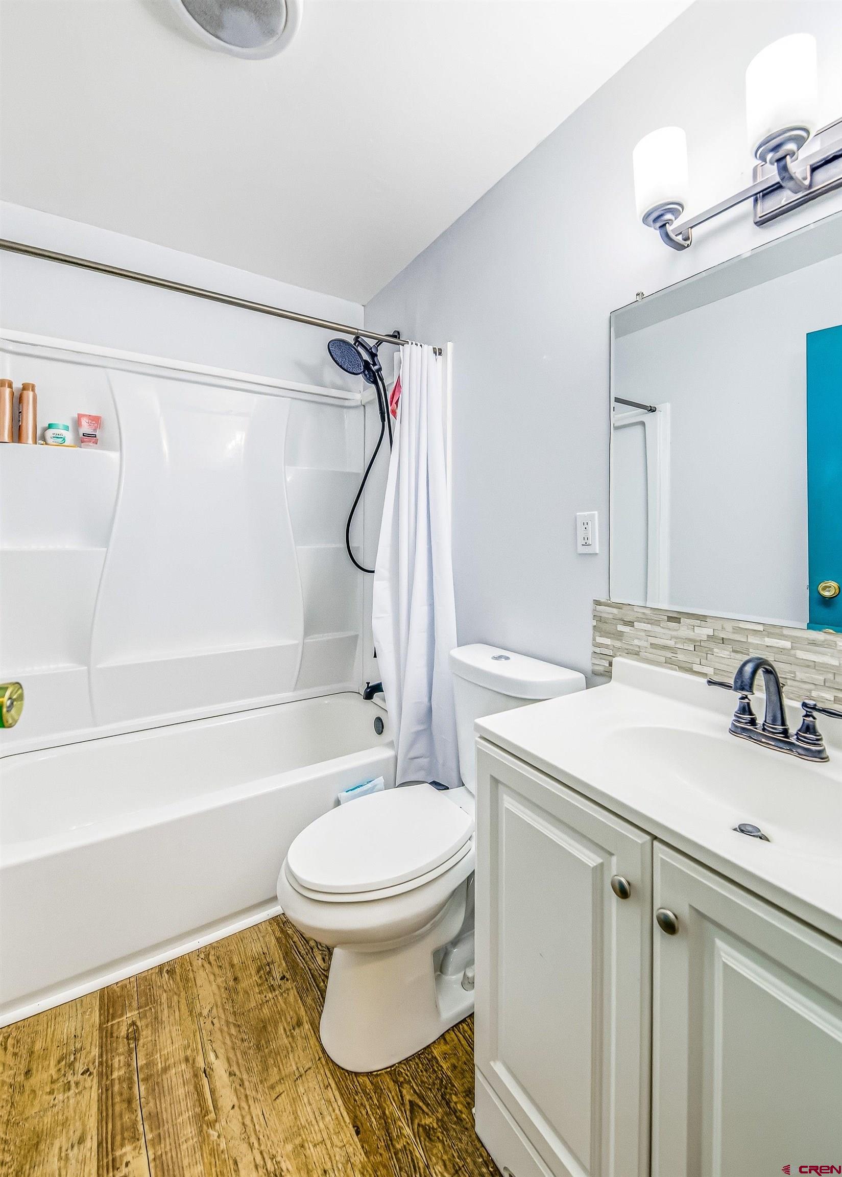 249 Park Street Delta, CO 81416 - Photo 8 of 22 a bathroom with a sink toilet and shower