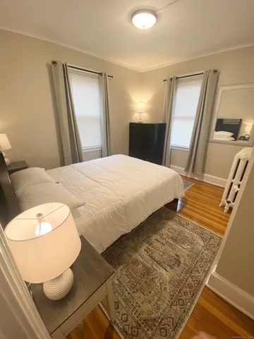 a bedroom with a bed and a mirror