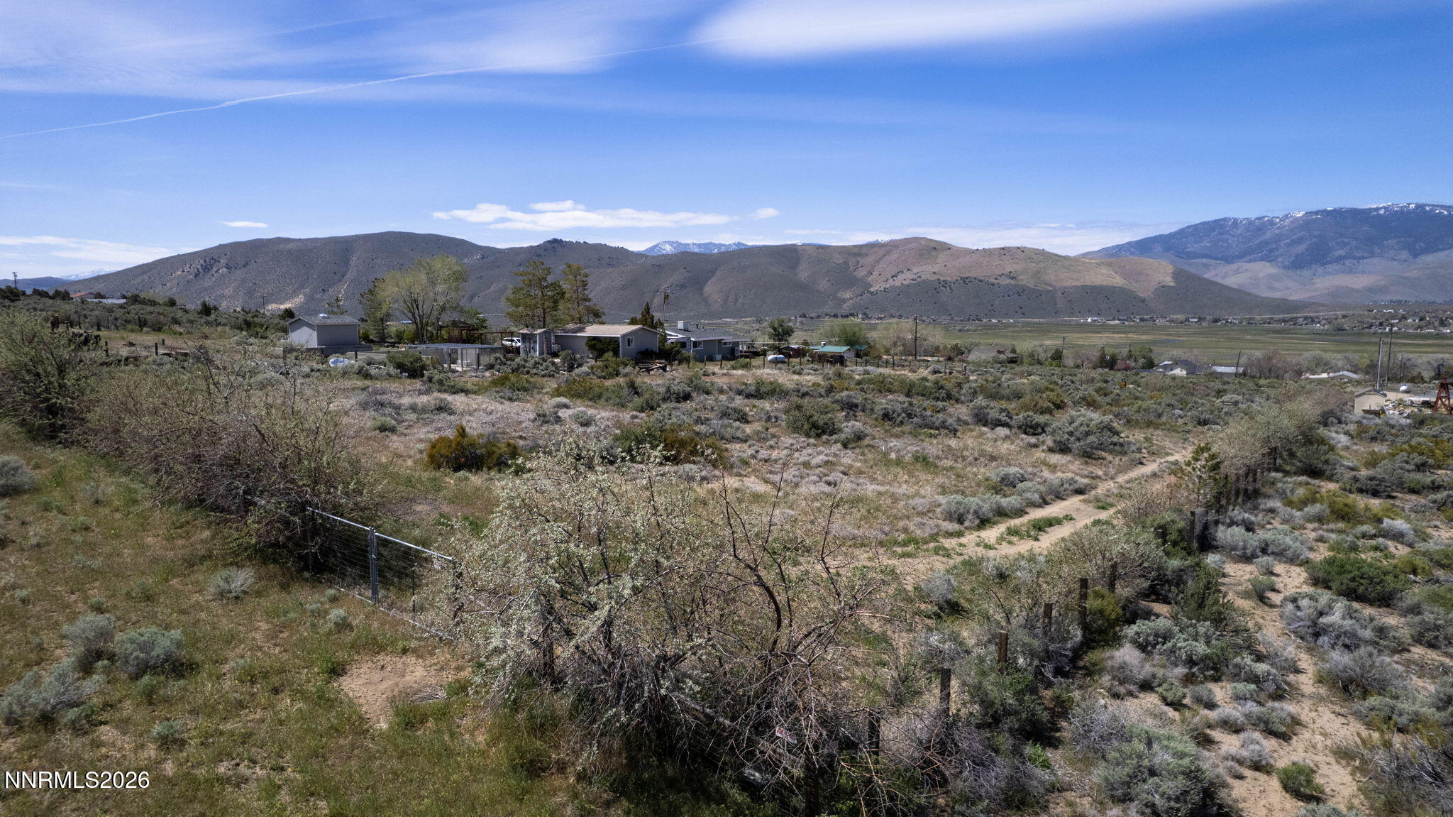 6260 Pursia Road Carson City, NV 89701 - Photo 11 of 26 a view of a lush green hillside and a houses