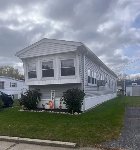 a front view of a house with a garden