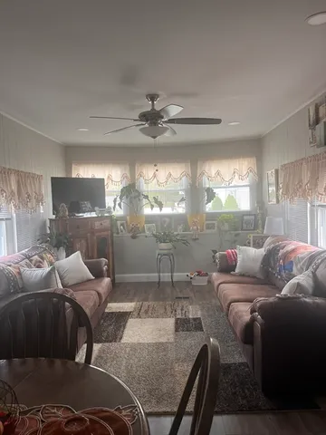 a living room with furniture and a chandelier