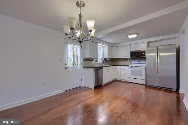 a view of a kitchen with a sink stainless steel appliances and cabinets