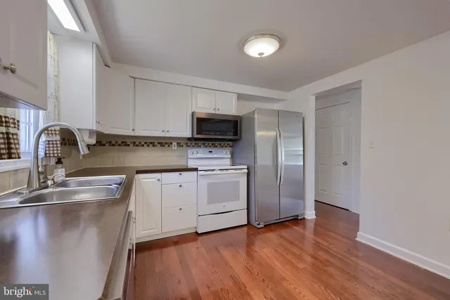 a kitchen with a sink appliances and cabinets