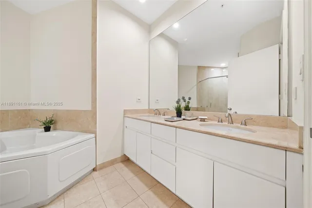 a bathroom with a tub sink and mirror