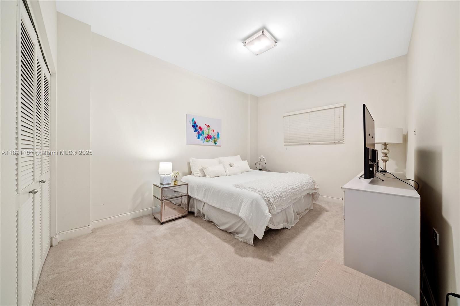 848 Brickell Key Drive, Unit 201 Miami, FL 33131 - Photo 17 of 31 a bedroom with a bed and a table