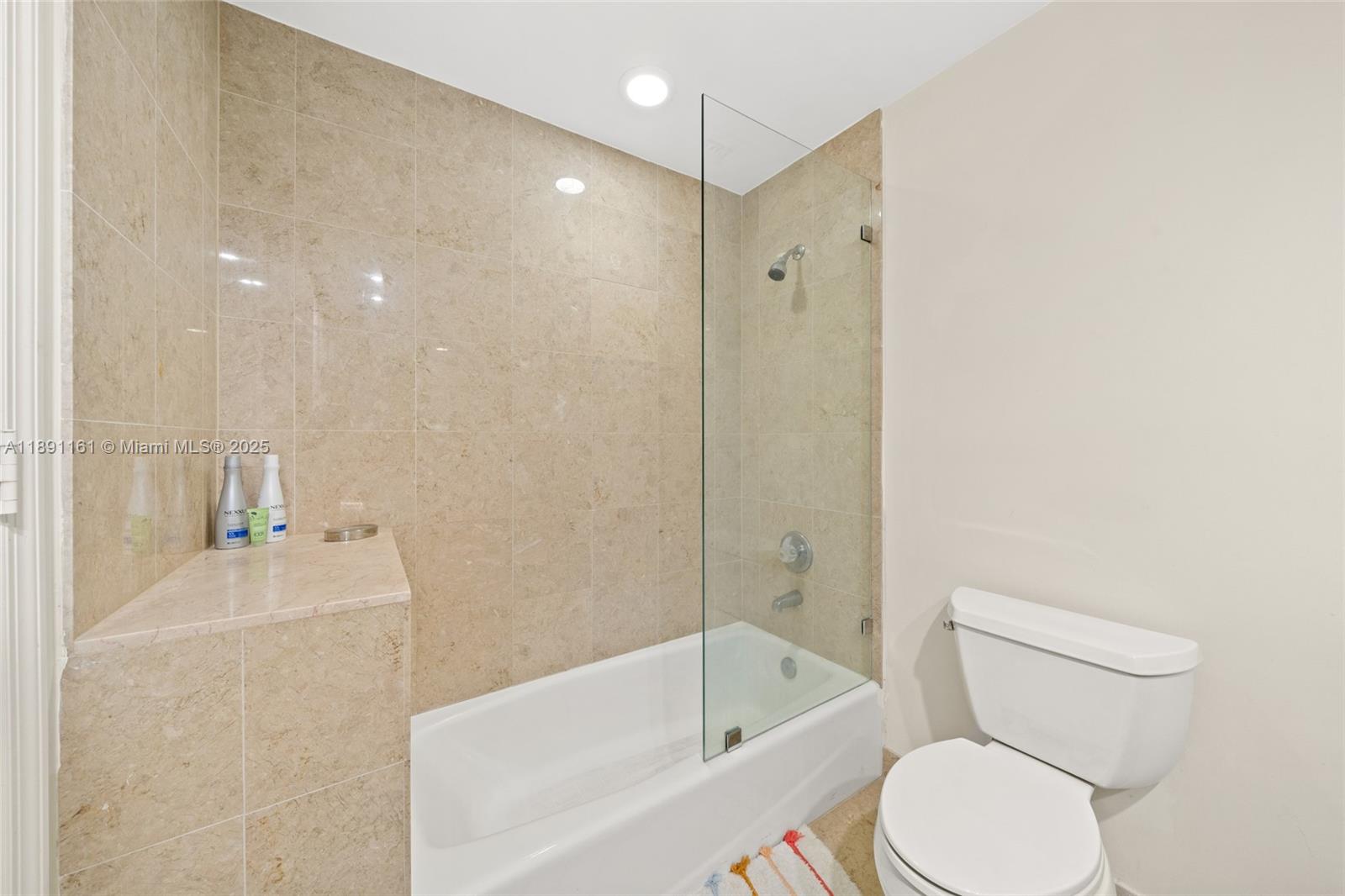 848 Brickell Key Drive, Unit 201 Miami, FL 33131 - Photo 18 of 31 a bathroom with a toilet sink and bathtub