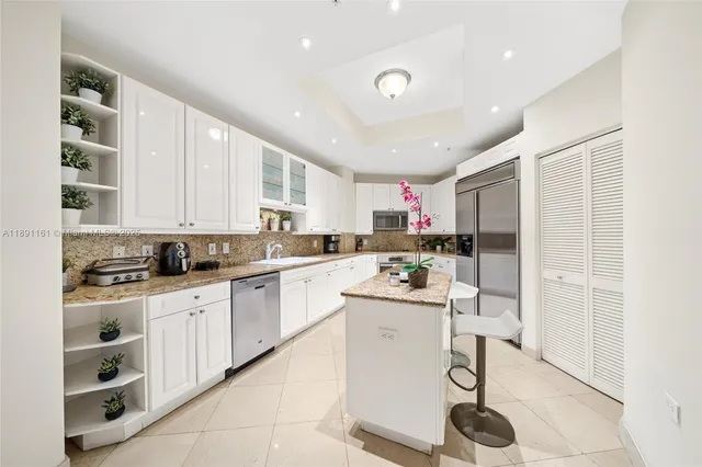 a kitchen with a sink window and cabinets