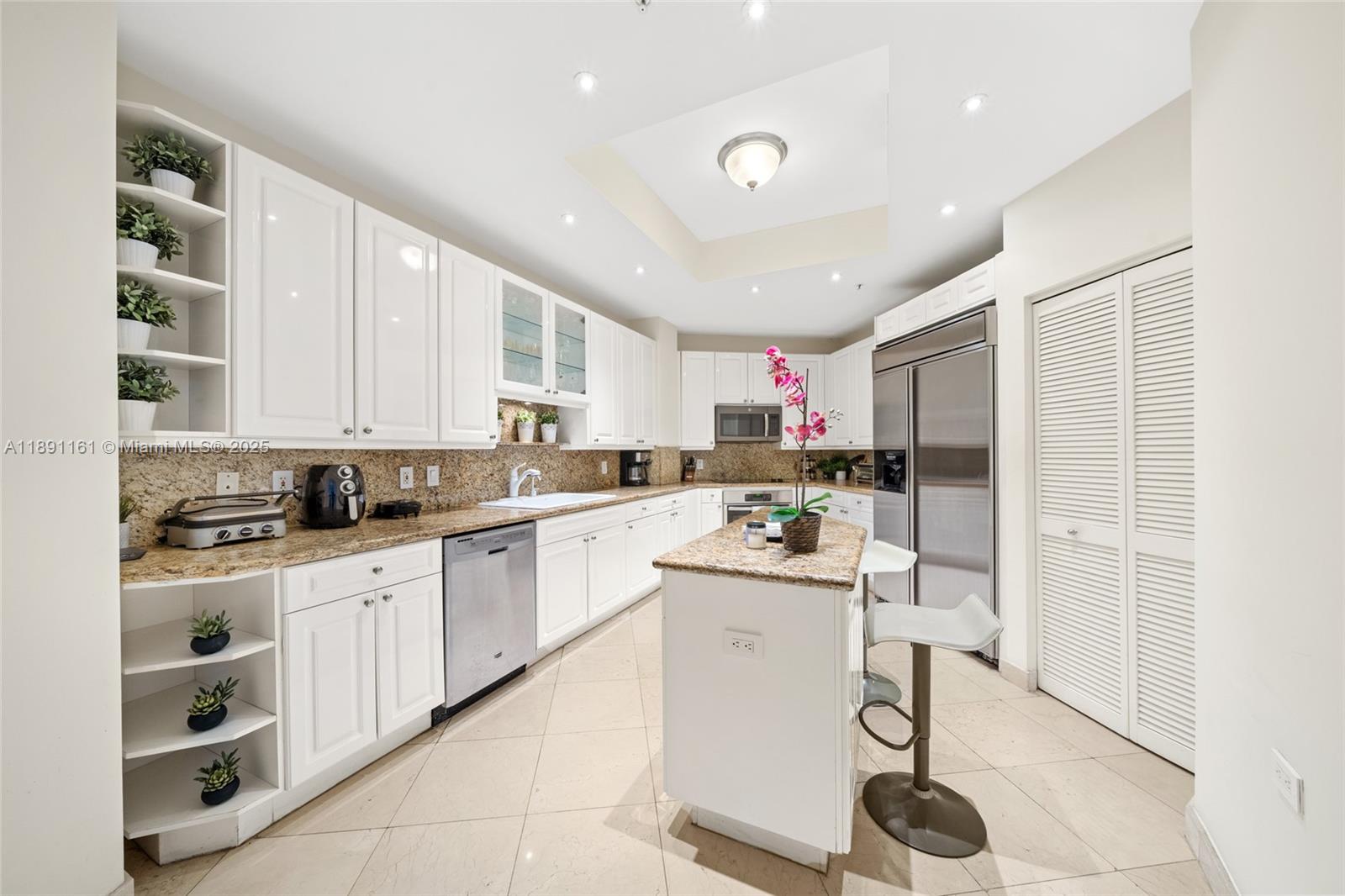 848 Brickell Key Drive, Unit 201 Miami, FL 33131 - Photo 27 of 31 a kitchen with a sink window and cabinets