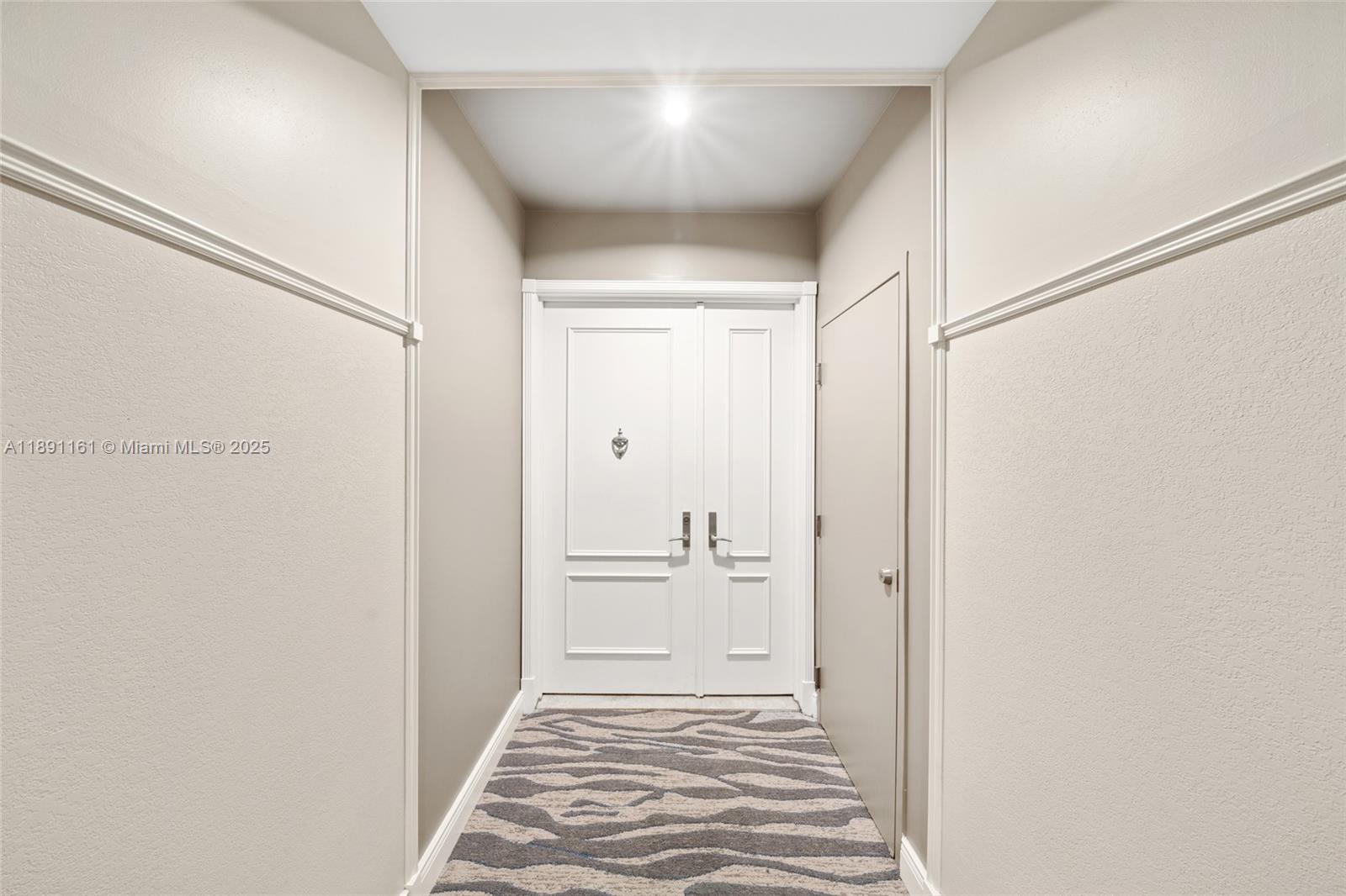 848 Brickell Key Drive, Unit 201 Miami, FL 33131 - Photo 31 of 31 a bathroom with a sink and a mirror