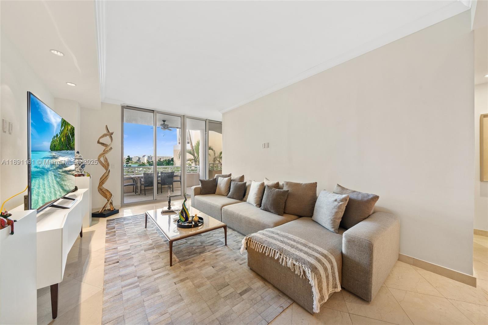 848 Brickell Key Drive, Unit 201 Miami, FL 33131 - Photo 6 of 31 a living room with furniture and a flat screen tv