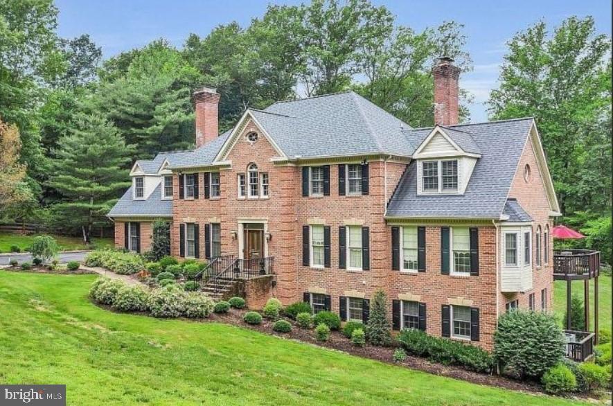 a aerial view of a brick house next to a yard