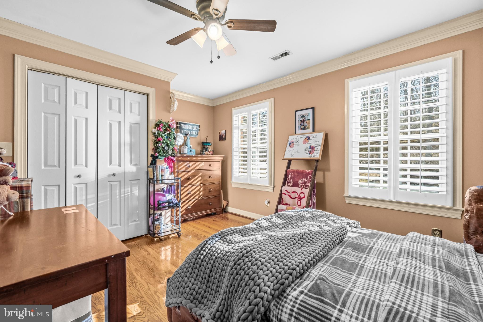 4514 Den Haag Road Warrenton, VA 20187 - Photo 30 of 56 a bedroom with a bed and a chandelier