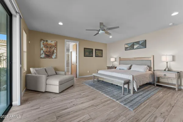 a spacious bedroom with a bed and a couch