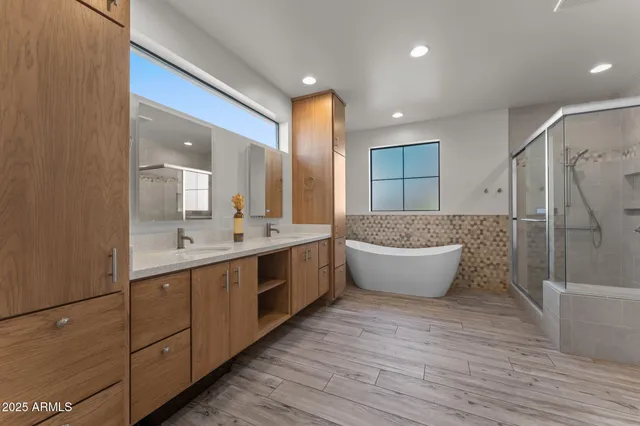 a large bathroom with a large tub and double vanity