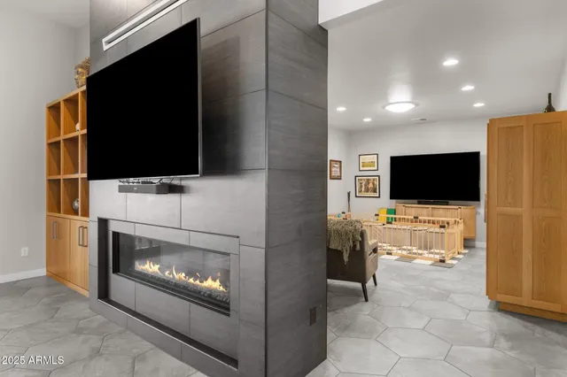 a living room with fireplace furniture and a flat screen tv