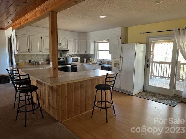 320 Luckadoo Road Bostic, NC 28018 - Photo 14 of 24 a kitchen with a table chairs refrigerator and cabinets