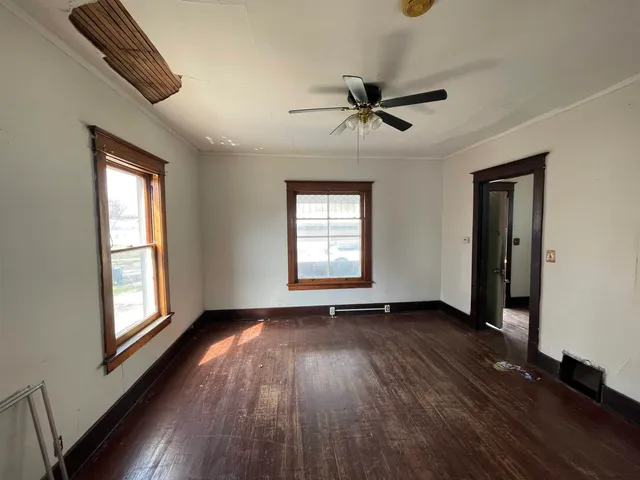 wooden floor in an empty room with a window
