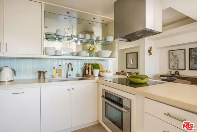a kitchen with cabinets and window